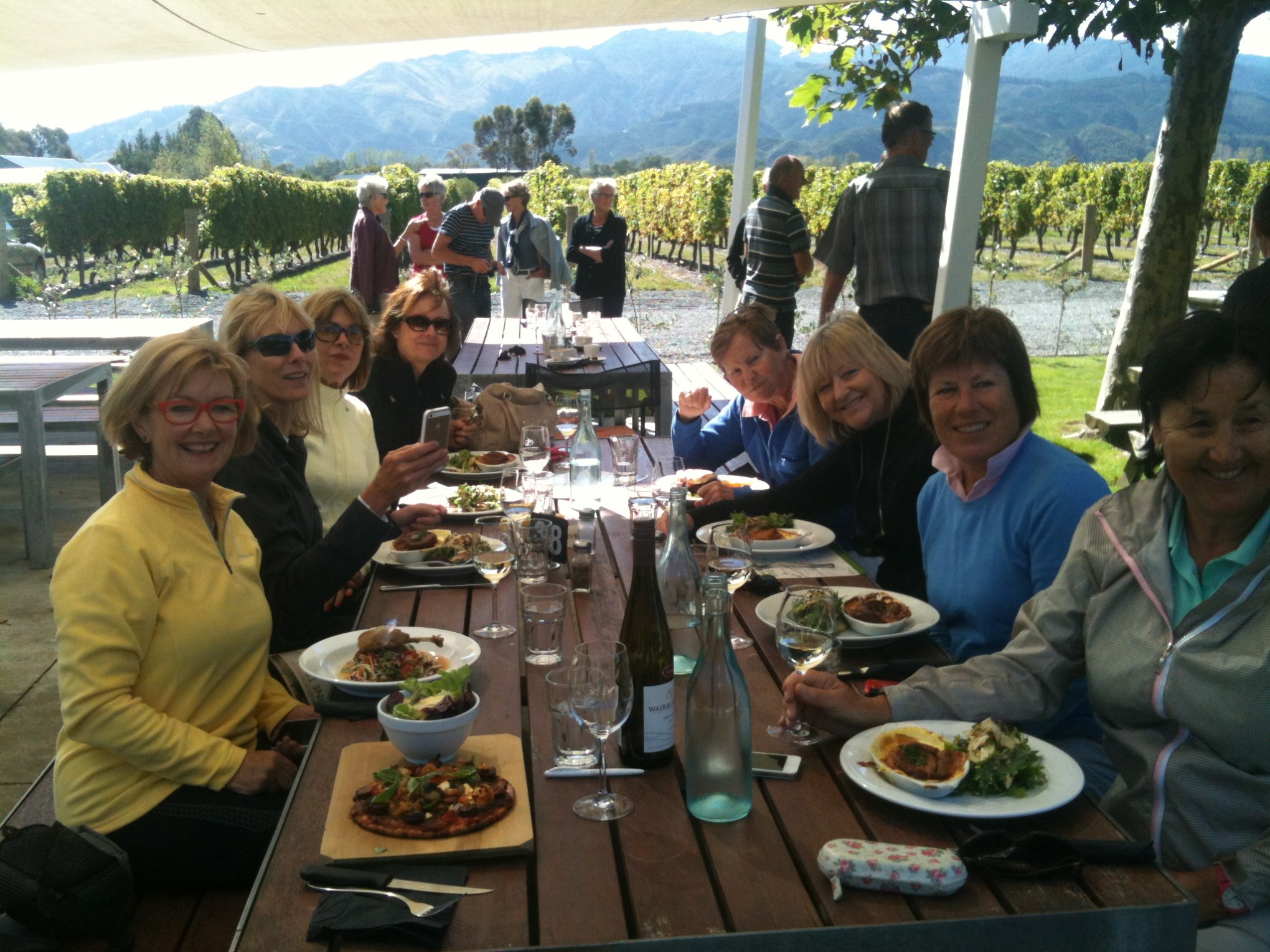 a group of people sitting at a table eating food