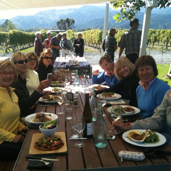 a group of people sitting at a table eating food