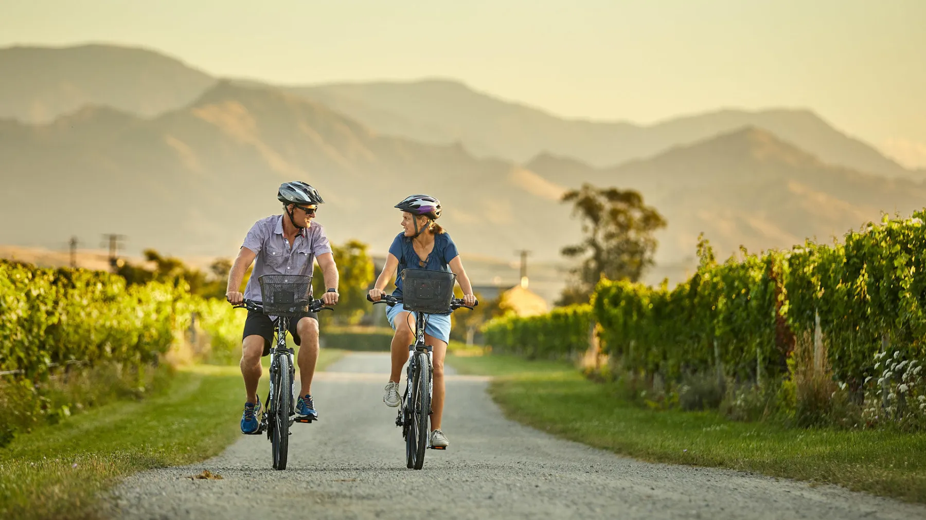 a man riding a bike down a dirt road