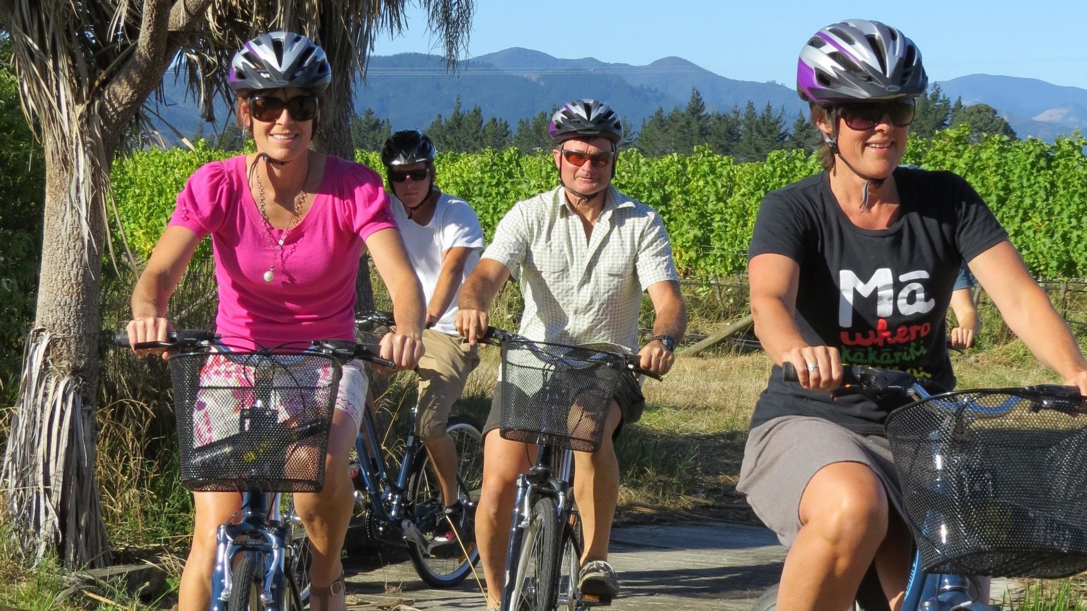 a group of people riding on the back of a bicycle