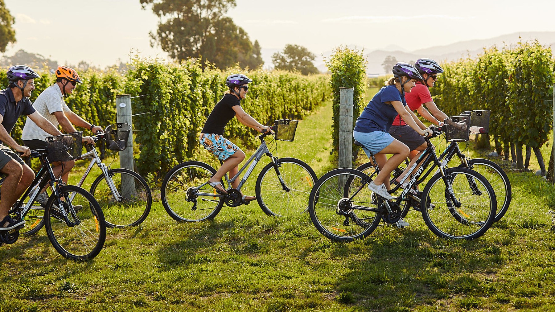 a group of people riding on the back of a bicycle