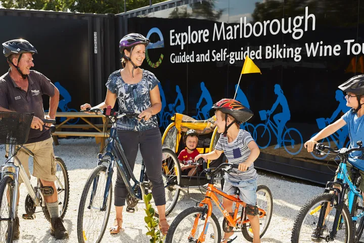 a group of people riding on the back of a bicycle