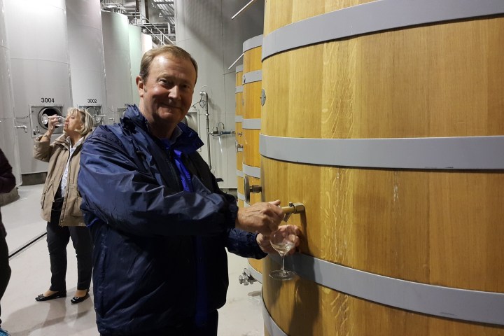 a person standing in front of a barrel