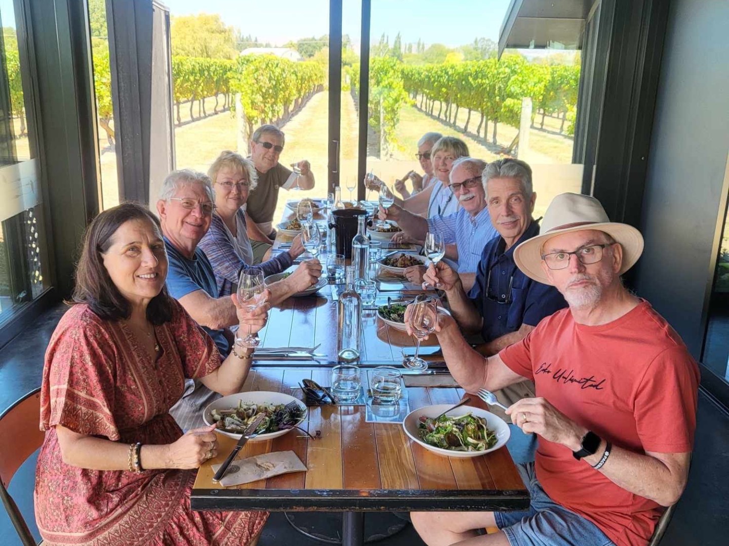 Rosemary McKenna et al. sitting at a table with wine glasses