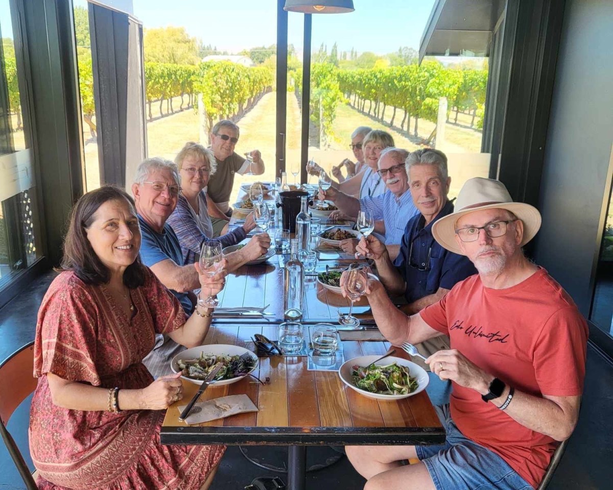 Rosemary McKenna et al. sitting at a table with wine glasses