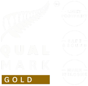 Qualmark Gold logo with fern and phrases 'Light Footprint', 'Safe & Sound', 'Warm Welcome'.