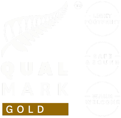 Qualmark Gold logo with fern and phrases 'Light Footprint', 'Safe & Sound', 'Warm Welcome'.