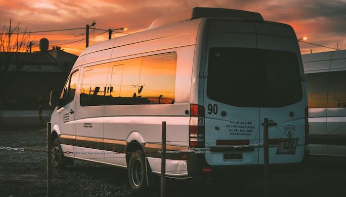 fachy-marin-800361-unsplash-1 a bus that is parked on the side of a road