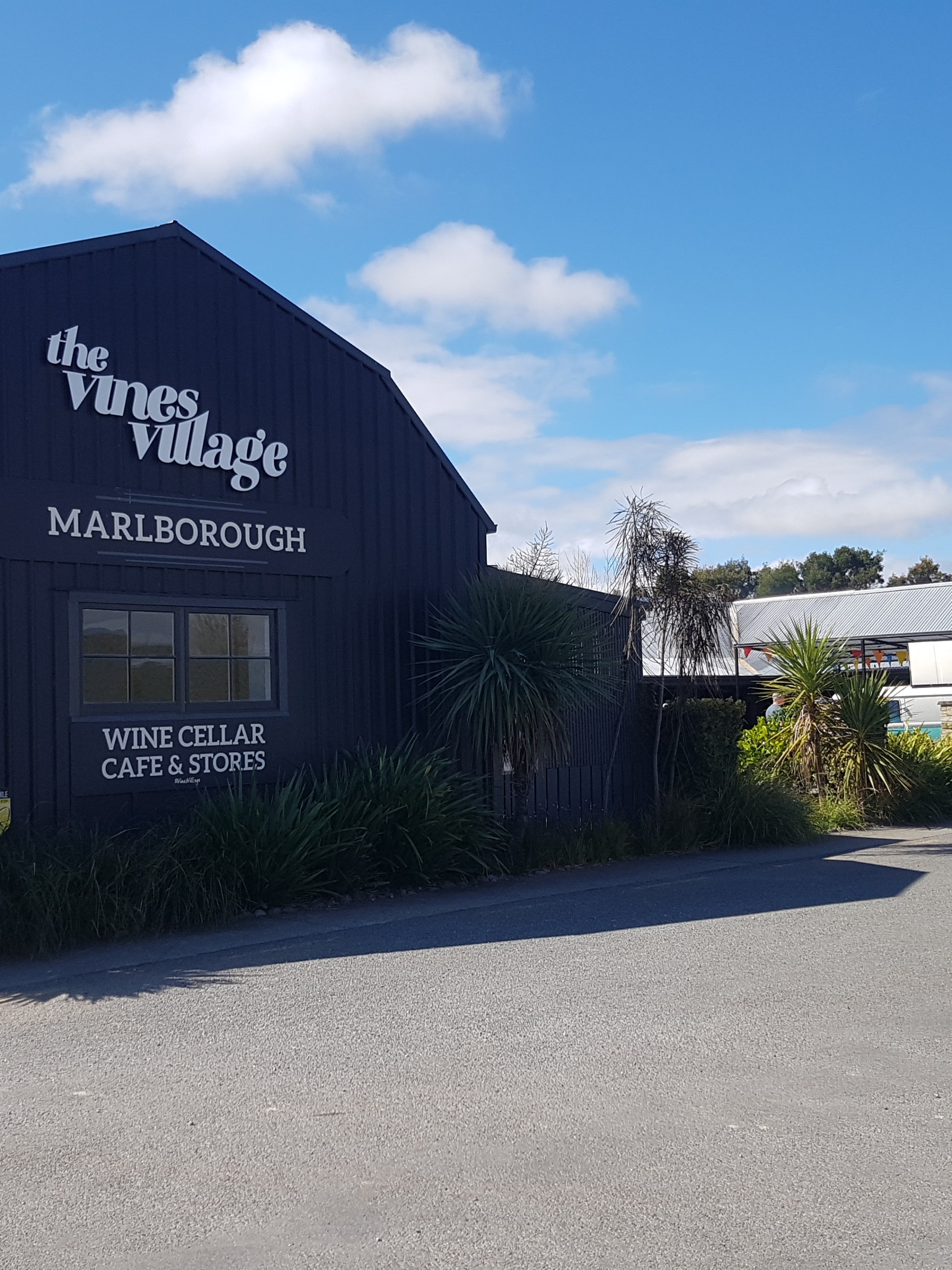 The Vines Village building with signs for wine cellar, cafe, stores in Marlborough.