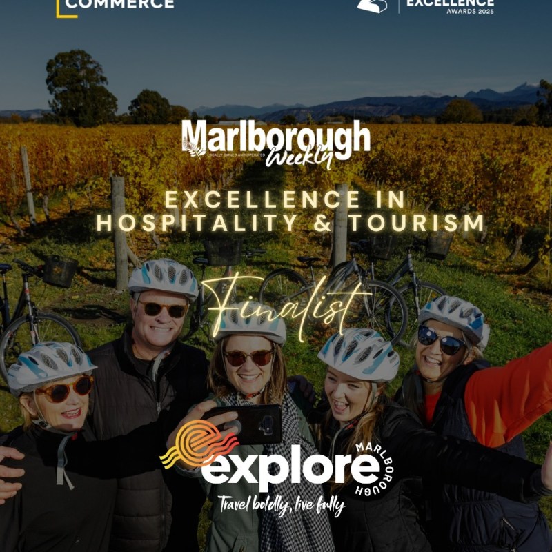 Group in helmets taking a selfie in a vineyard, with text about Marlborough tourism award.