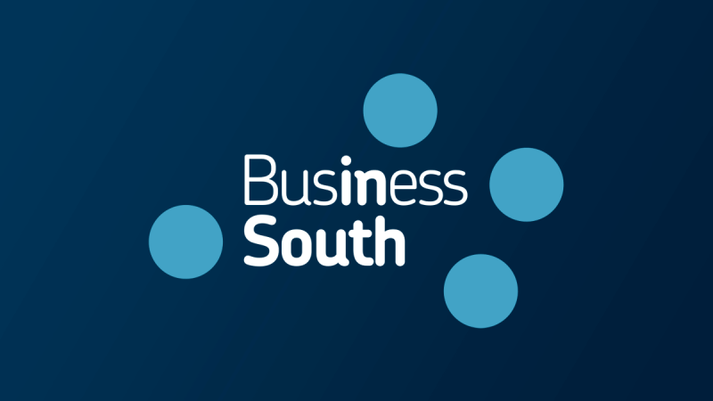Business South logo with five blue dots on dark background.